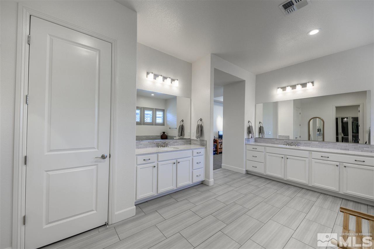 9745 Cardigan Bay Lane Reno, NV 89521 - Photo 14 of 25 a large white kitchen with cabinets and sink