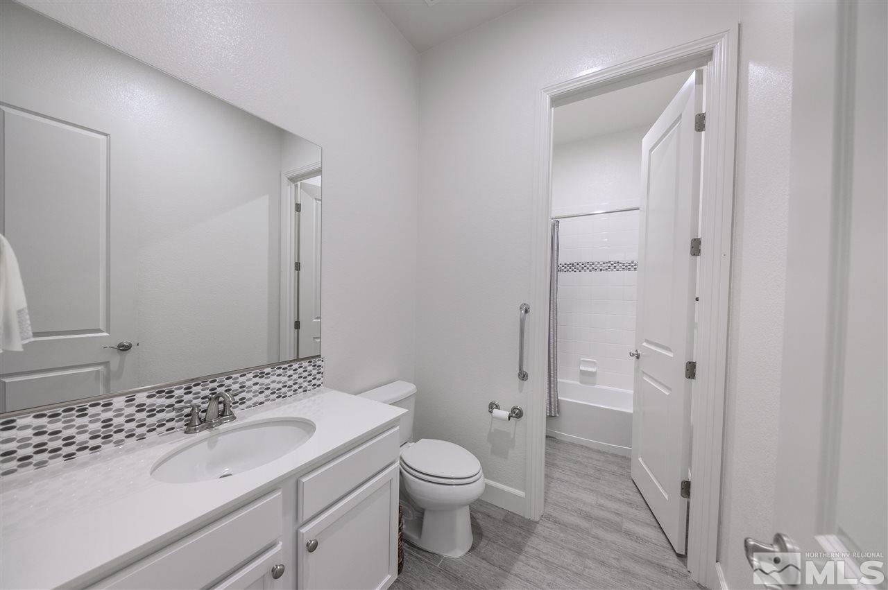 9745 Cardigan Bay Lane Reno, NV 89521 - Photo 17 of 25 a bathroom with a sink a toilet and shower