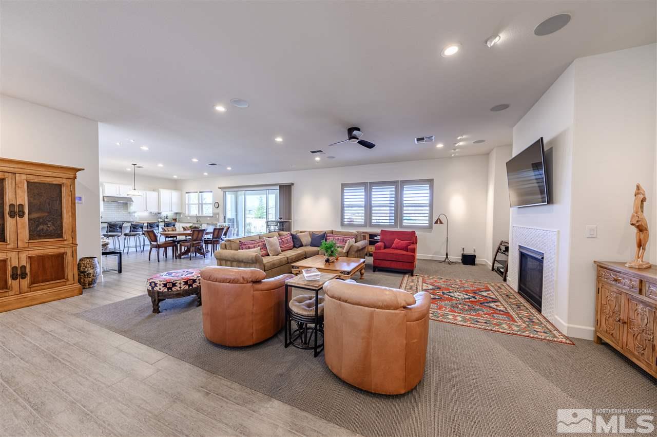 9745 Cardigan Bay Lane Reno, NV 89521 - Photo 3 of 25 a living room with furniture a fireplace and a flat screen tv