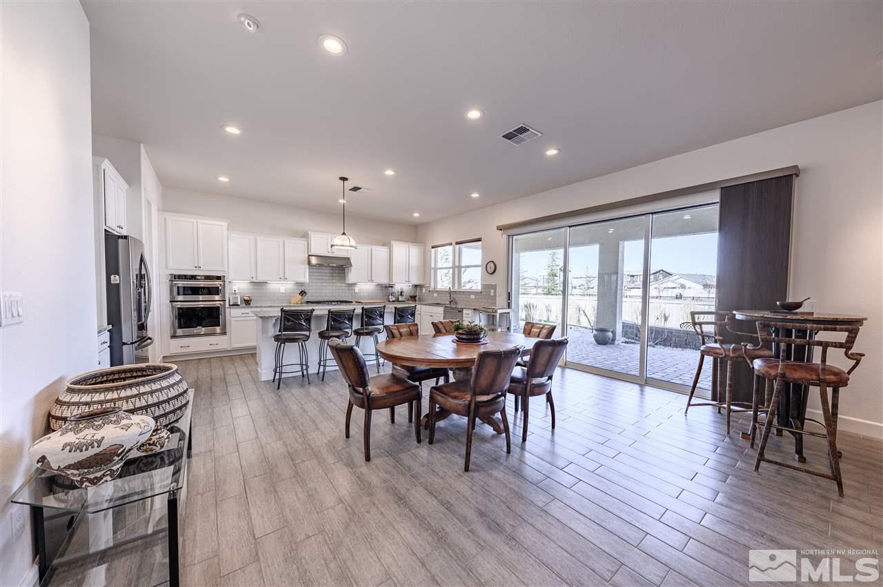 9745 Cardigan Bay Lane Reno, NV 89521 - Photo 5 of 25 a view of a dining room with furniture and wooden floor