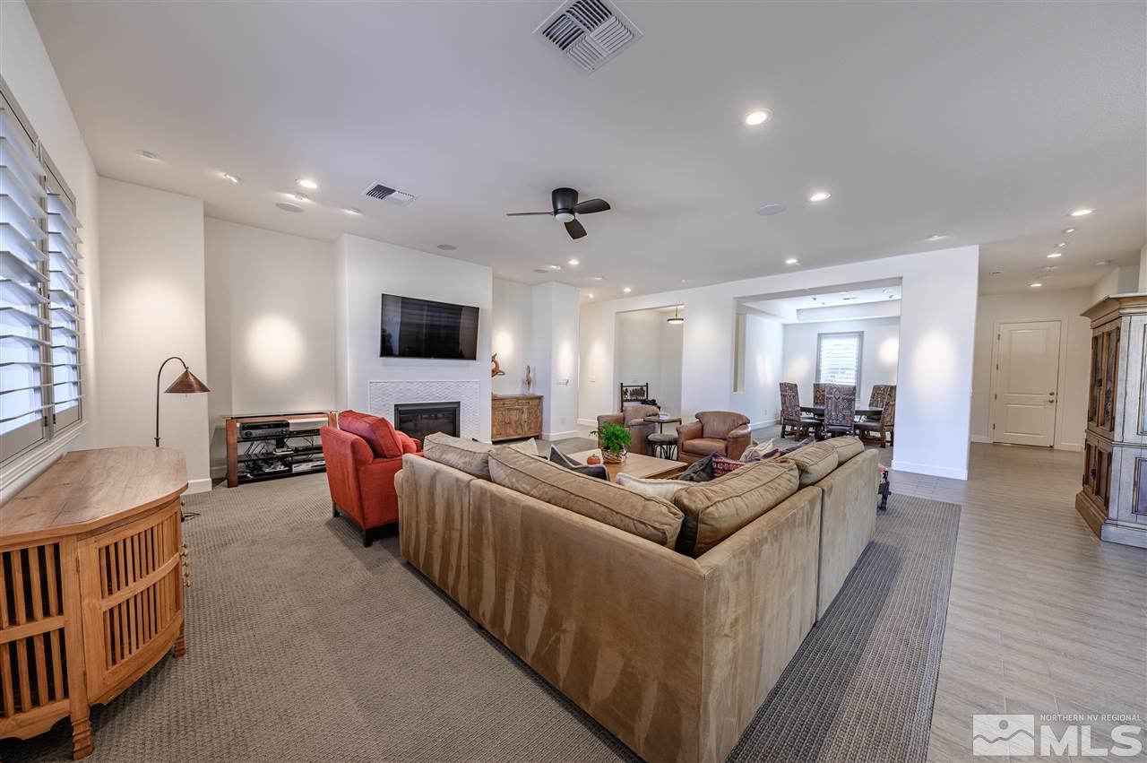 9745 Cardigan Bay Lane Reno, NV 89521 - Photo 6 of 25 a living room with furniture a flat screen tv and a ceiling fan