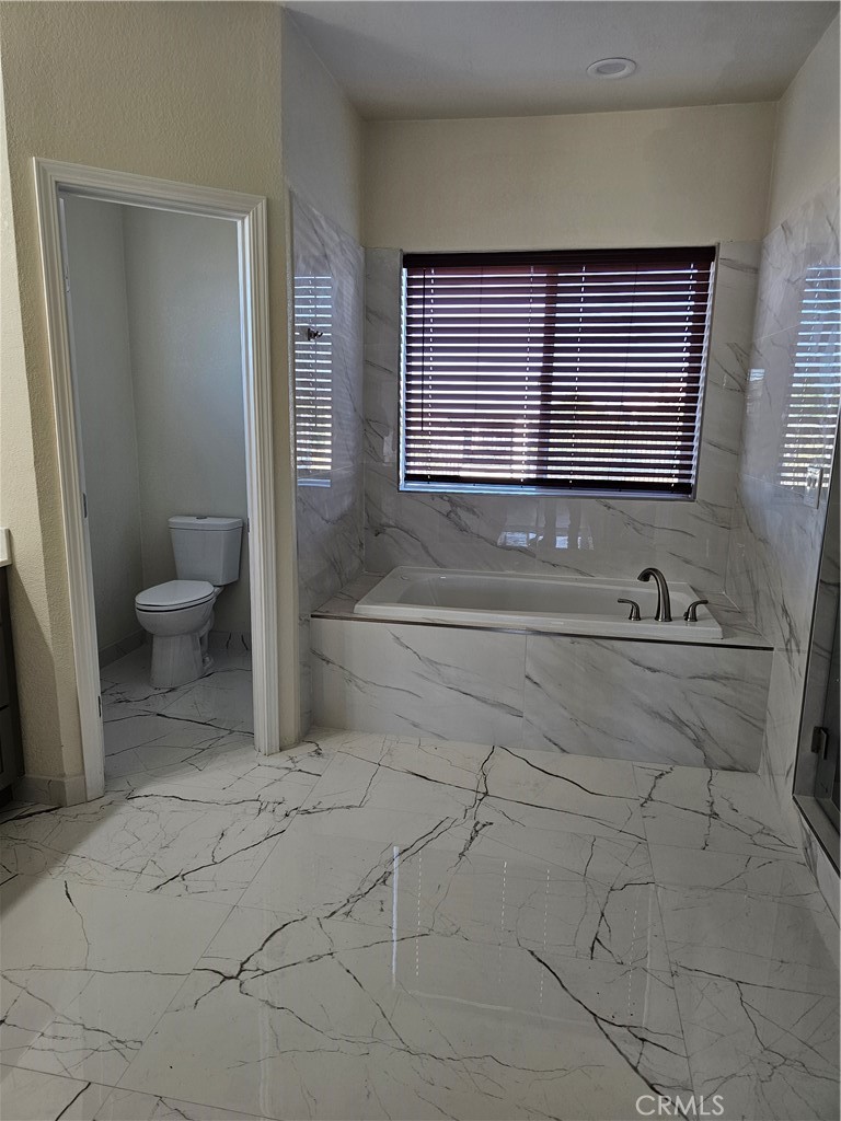 8630 Sahara Road Phelan, CA 92371 - Photo 13 of 21 a bathroom with a sink a toilet and a mirror
