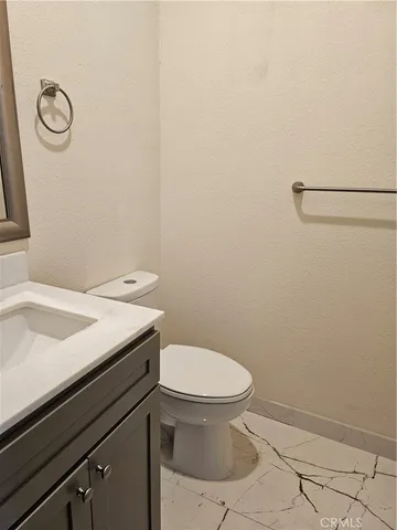 a bathroom with a sink a toilet and a vanity