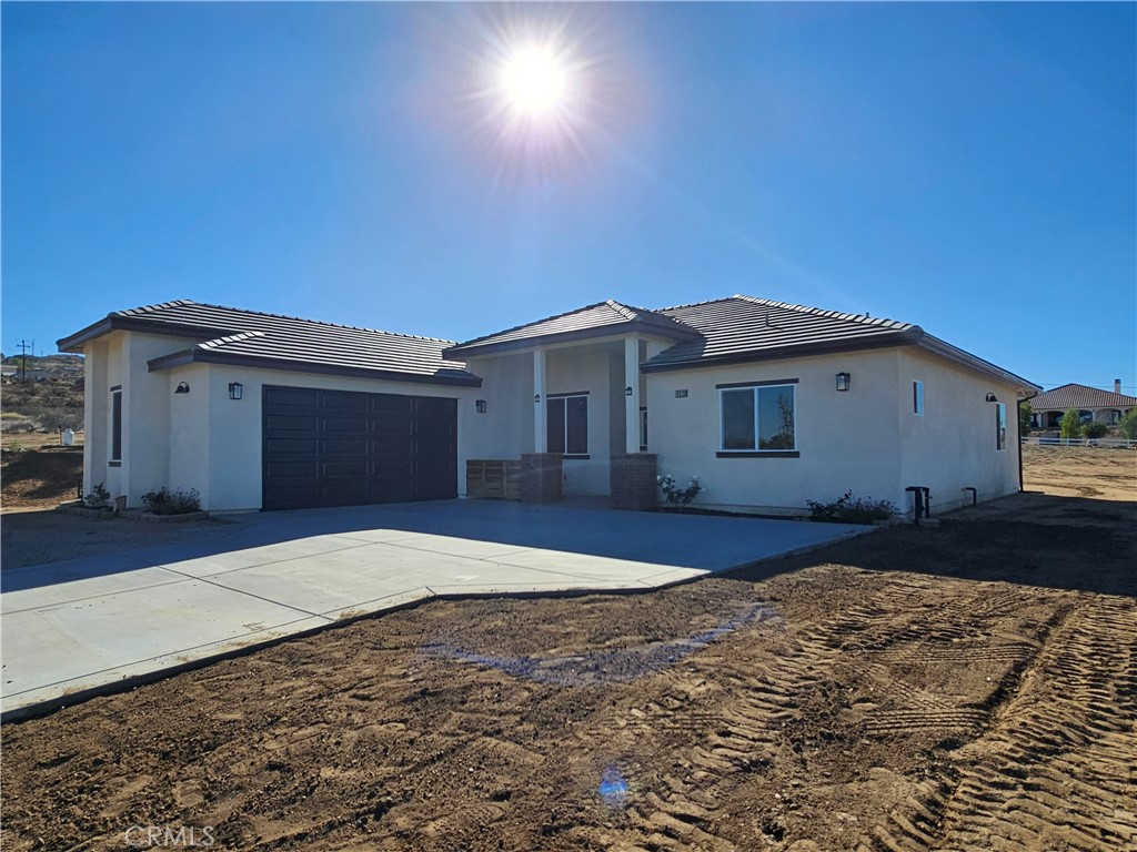 8630 Sahara Road Phelan, CA 92371 - Photo 2 of 21 a front view of a house with a yard