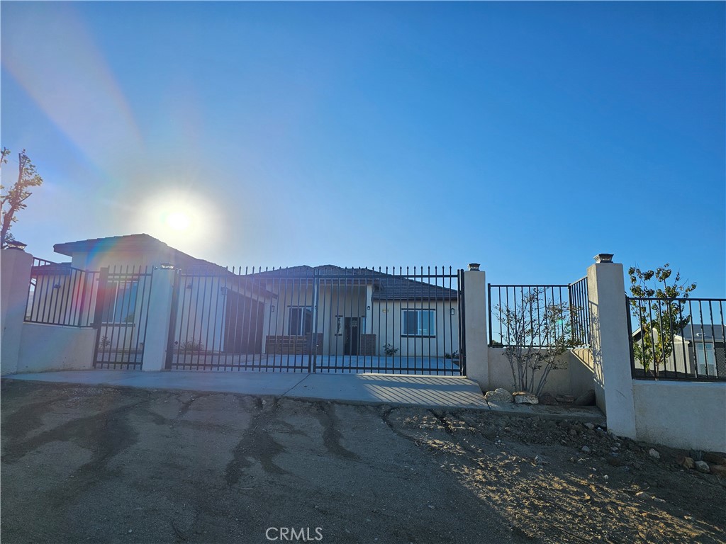 8630 Sahara Road Phelan, CA 92371 - Photo 3 of 21 a view of a house with a wooden fence