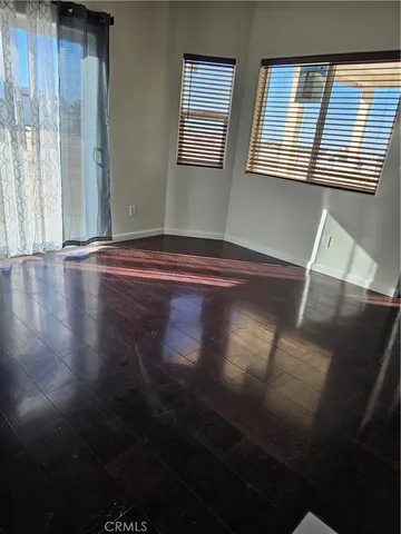 a view of room with window and wooden floor