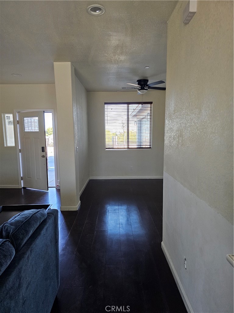 8630 Sahara Road Phelan, CA 92371 - Photo 9 of 21 an empty room with wooden floor and windows