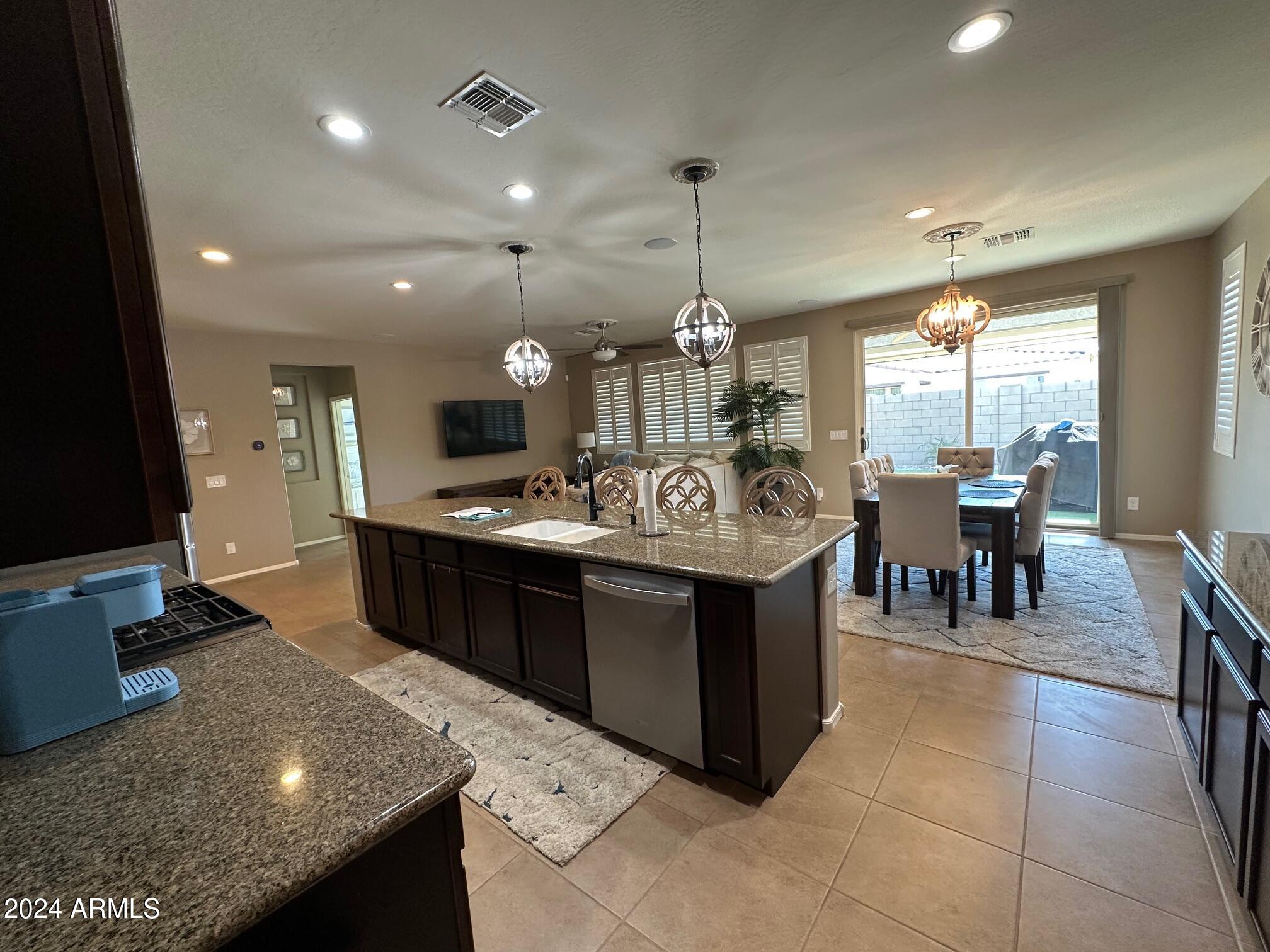 22469 East Camina Plata Queen Creek, AZ 85142 - Photo 11 of 38 a large kitchen with a table and chairs