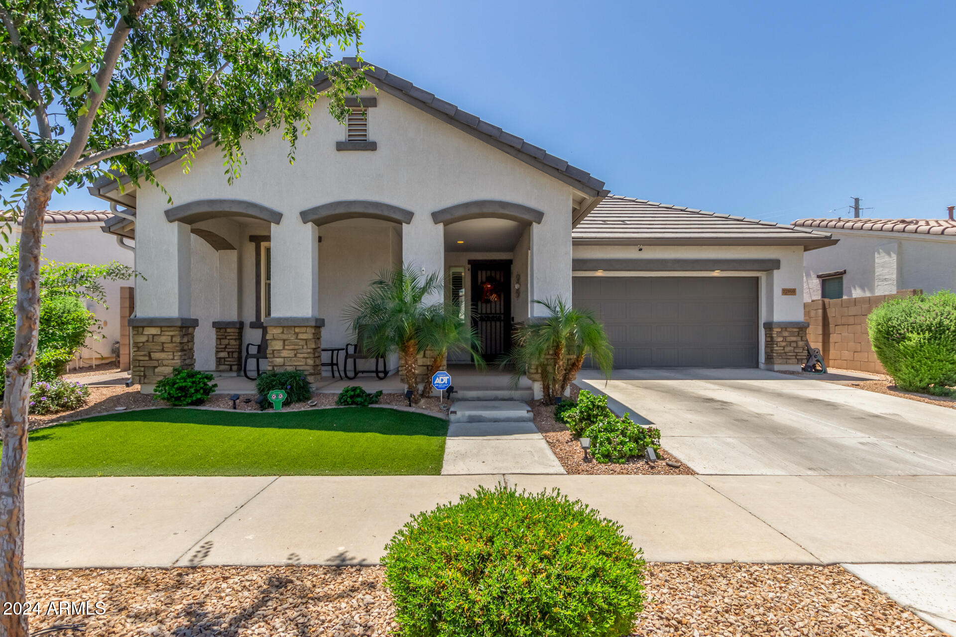 22469 East Camina Plata Queen Creek, AZ 85142 - Photo 2 of 38 a front view of a house with garden