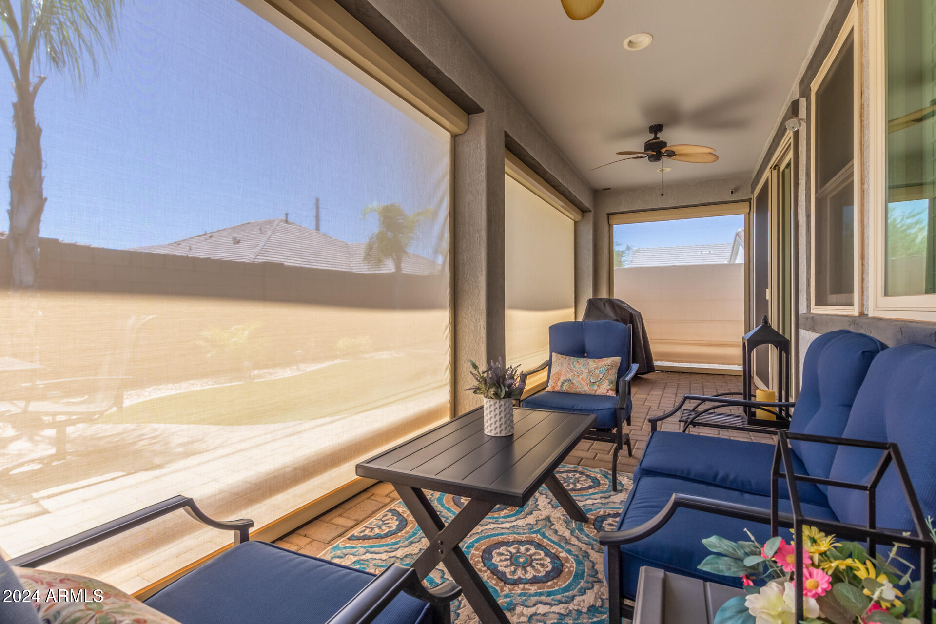 22469 East Camina Plata Queen Creek, AZ 85142 - Photo 29 of 38 a living room with furniture a flat screen tv and a floor to ceiling window