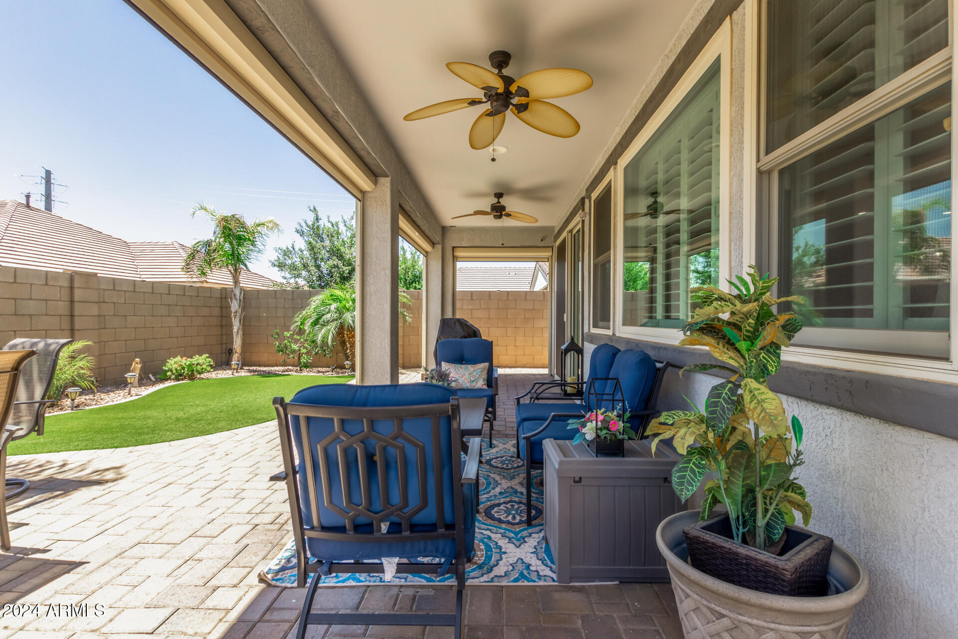 22469 East Camina Plata Queen Creek, AZ 85142 - Photo 33 of 38 a living room filled with furniture and a garden