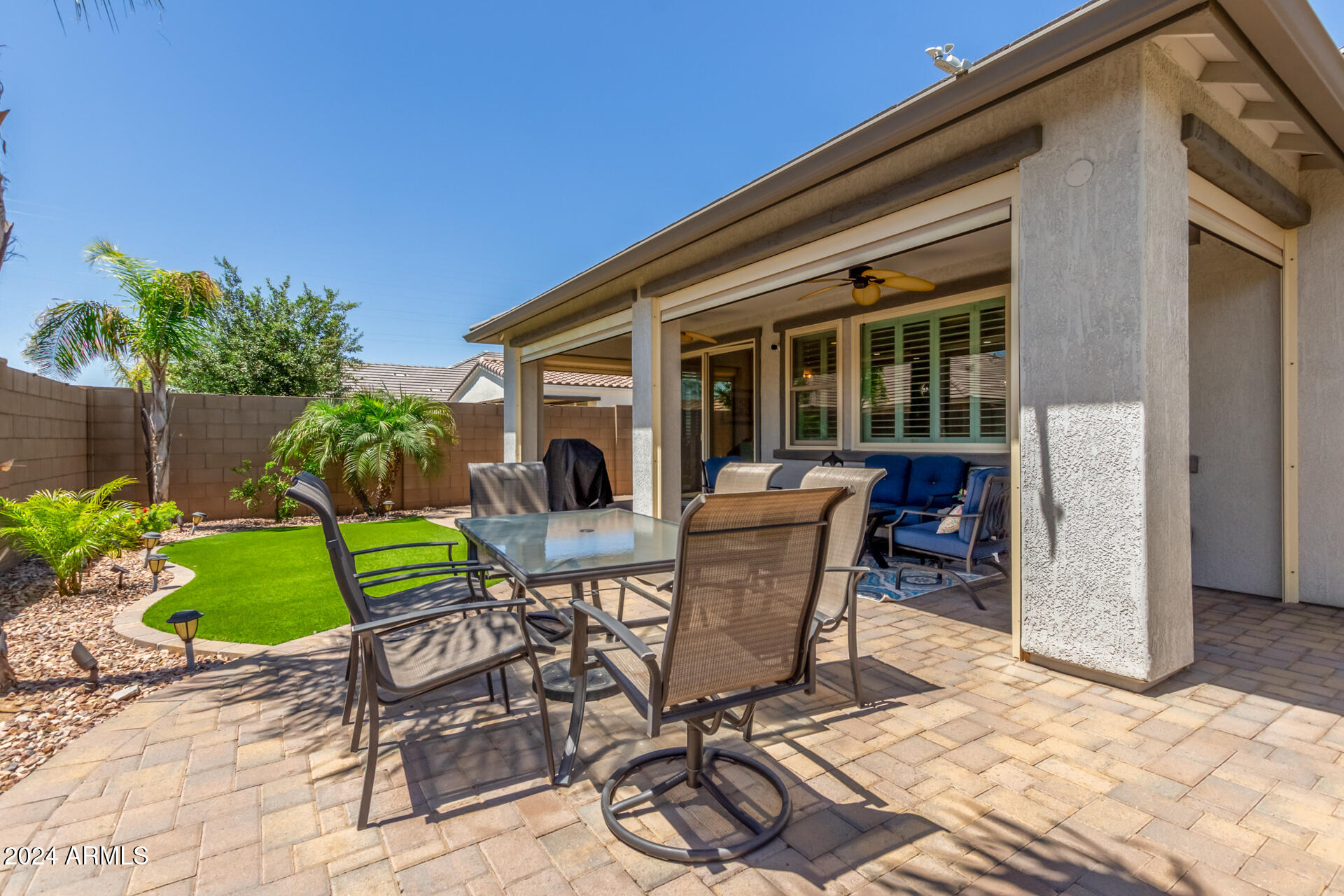 22469 East Camina Plata Queen Creek, AZ 85142 - Photo 34 of 38 a view of a patio with table and chairs potted plants and floor to ceiling window