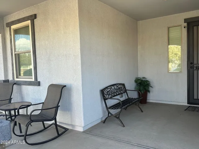 a view of workspace with a couch and a potted plant
