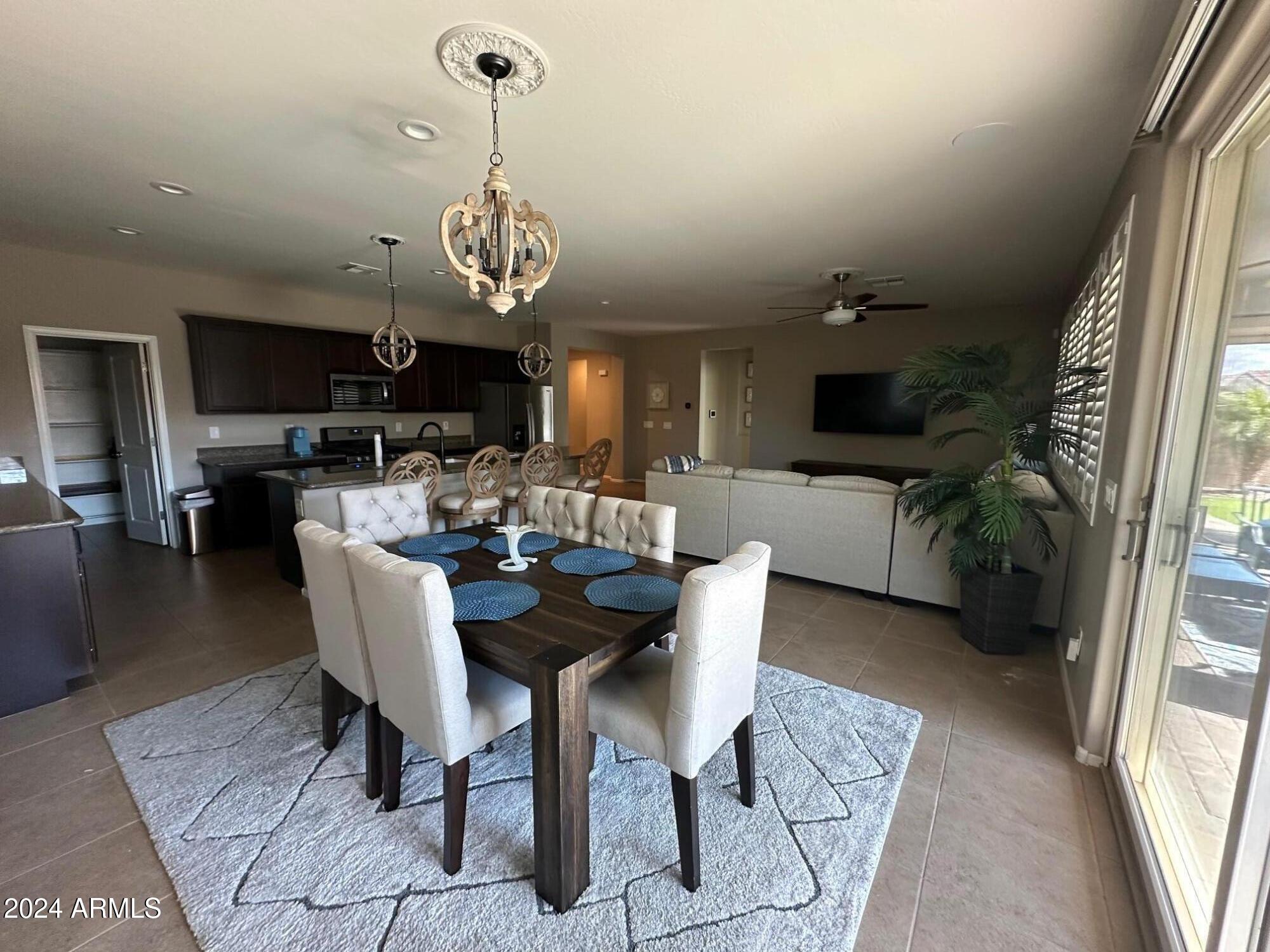 22469 East Camina Plata Queen Creek, AZ 85142 - Photo 8 of 38 a view of a dining room with furniture window and wooden floor