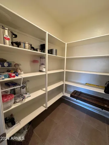 a large kitchen with a table and chairs