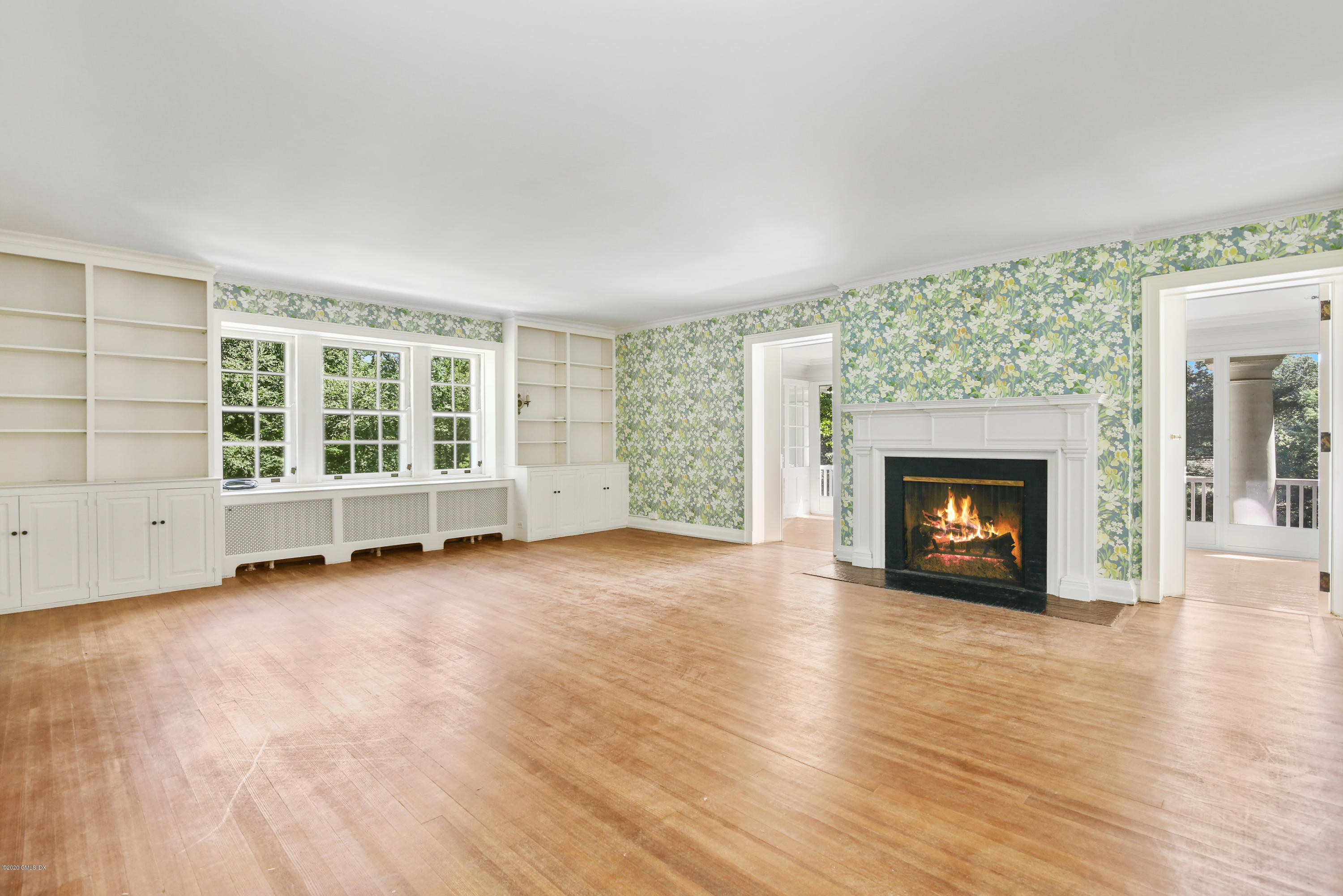 51 Doubling Road Greenwich, CT 06830 - Photo 13 of 24 an empty room with wooden floor fireplace and windows
