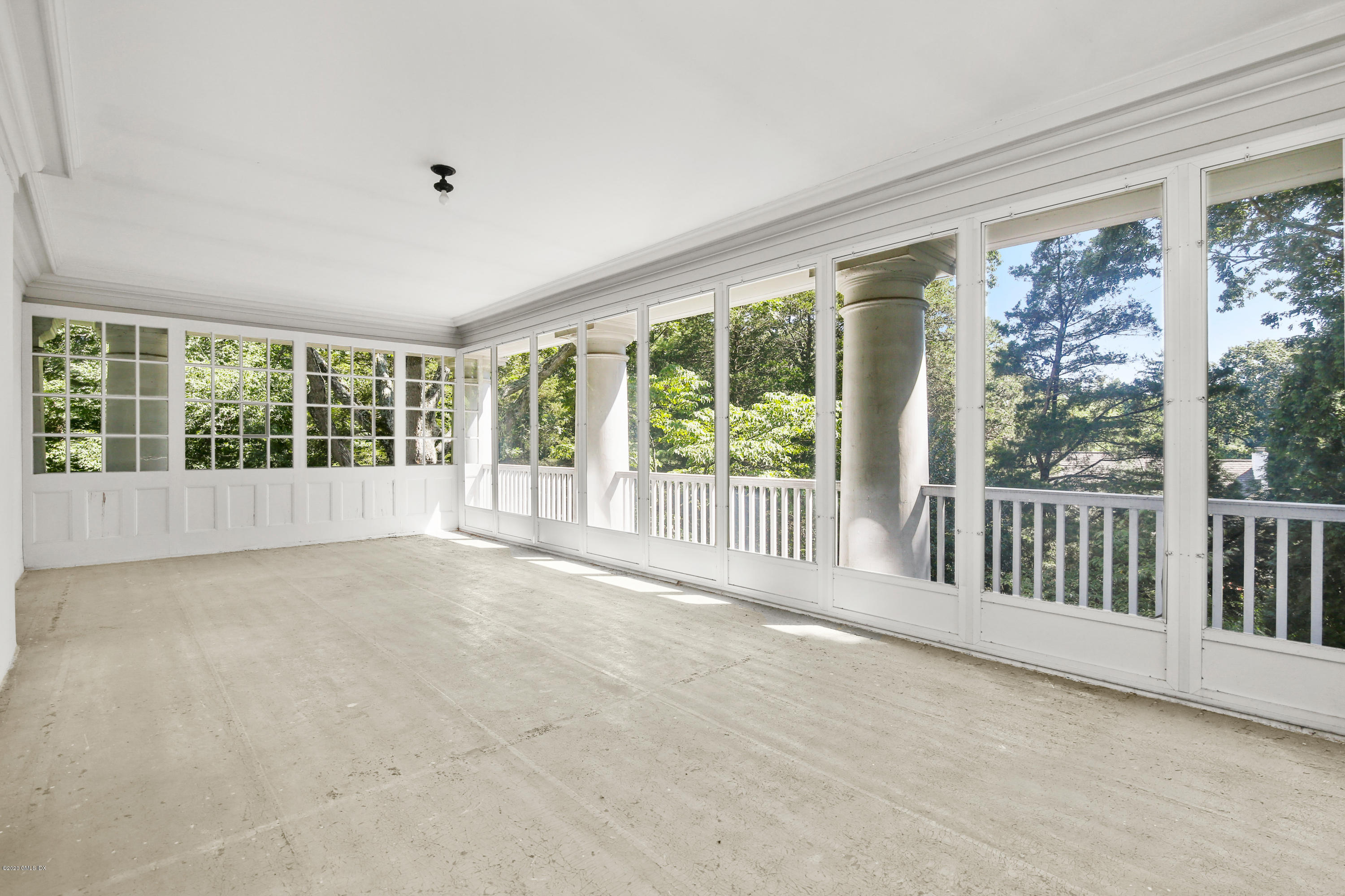 51 Doubling Road Greenwich, CT 06830 - Photo 14 of 24 a view of an empty room with wooden floor and garden