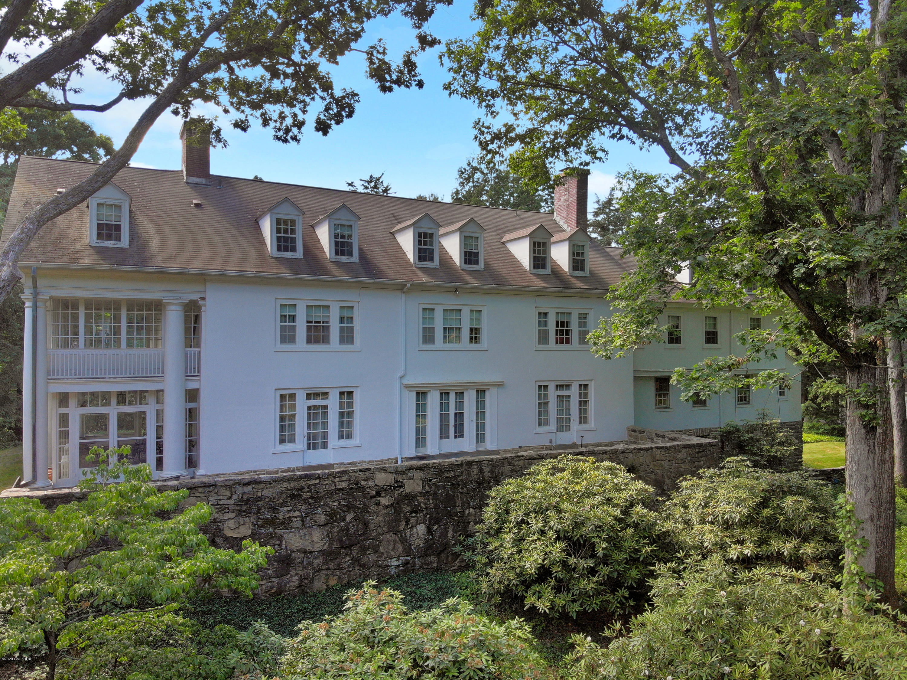 51 Doubling Road Greenwich, CT 06830 - Photo 15 of 24 a front view of a residential apartment building with a yard