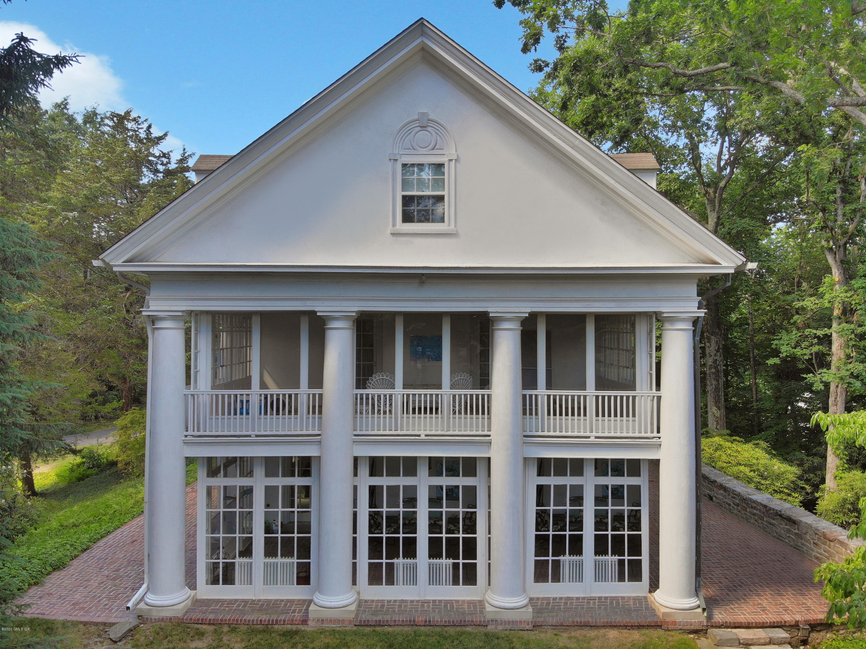 51 Doubling Road Greenwich, CT 06830 - Photo 3 of 24 a front view of a house with a garden