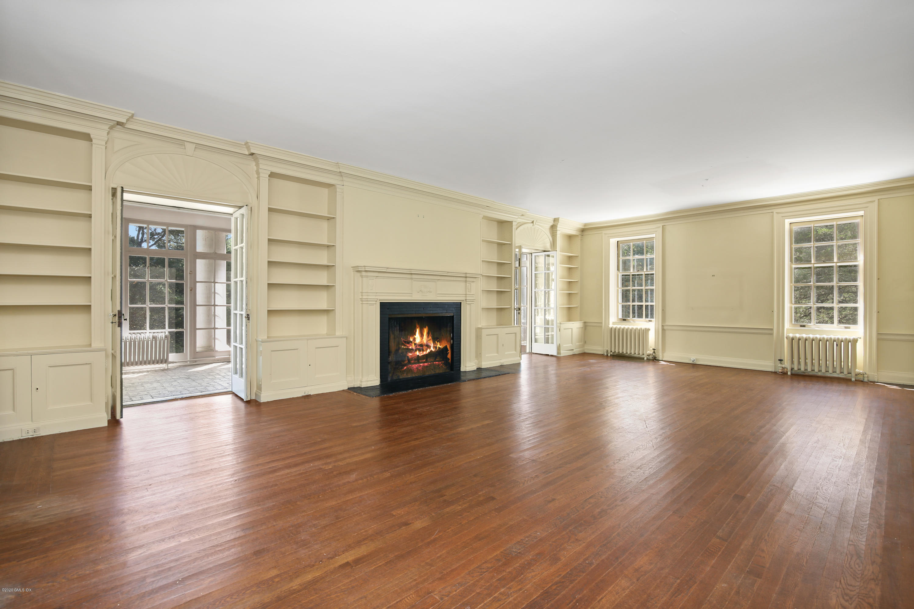 51 Doubling Road Greenwich, CT 06830 - Photo 7 of 24 an empty room with wooden floor and fireplace