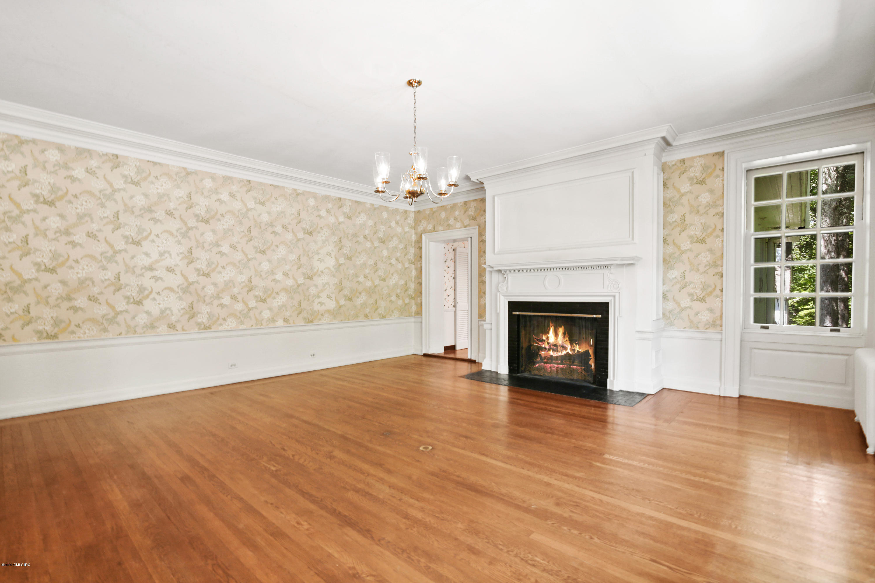 51 Doubling Road Greenwich, CT 06830 - Photo 9 of 24 a view of an empty room with wooden floor fireplace and a window