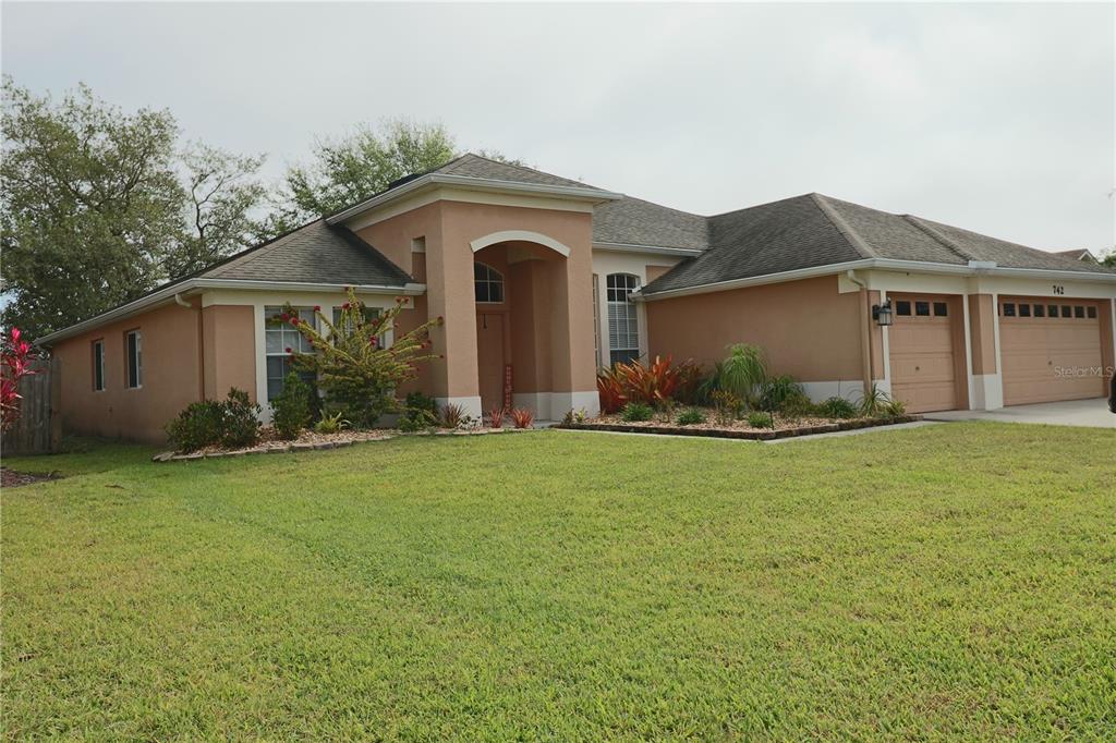 a front view of a house with garden
