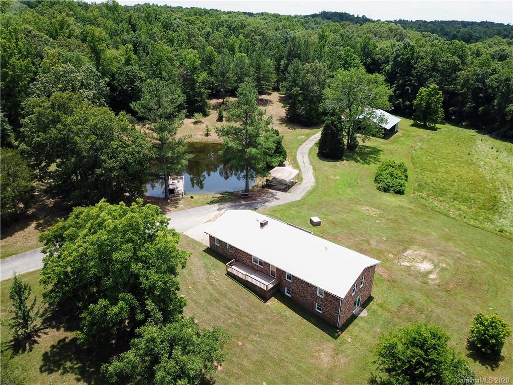an aerial view of a house with a yard basket ball court and outdoor seating