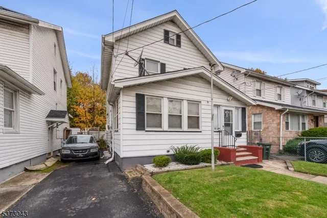 a front view of a house with a garden and yard