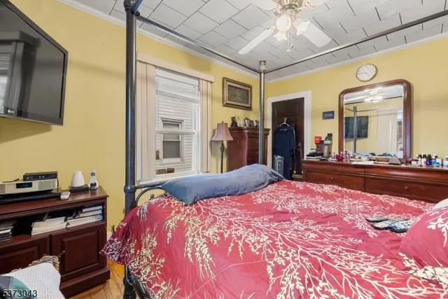 a bedroom with a large bed and a chandelier