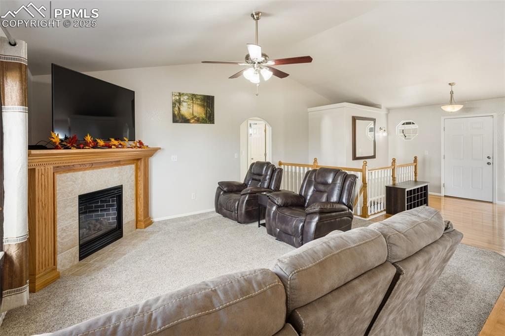 8449 Copenhagen Road Peyton, CO 80831 - Photo 17 of 49 a living room with furniture a flat screen tv and a fireplace