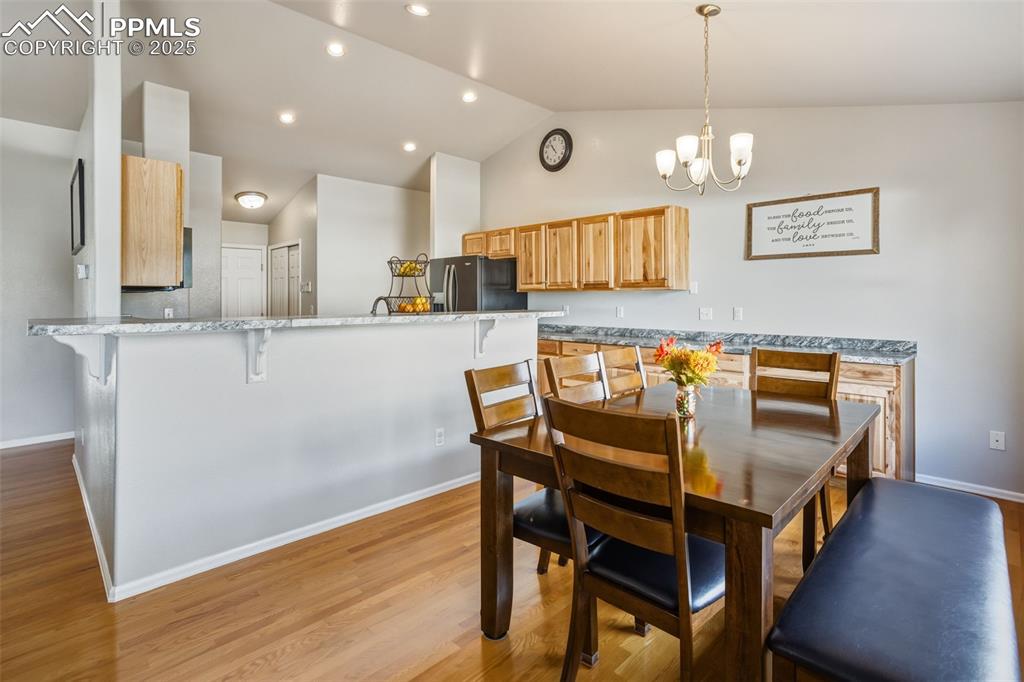 8449 Copenhagen Road Peyton, CO 80831 - Photo 20 of 49 a dining room with wooden floor and chandelier