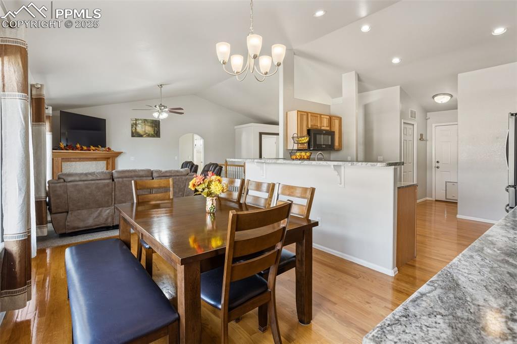 8449 Copenhagen Road Peyton, CO 80831 - Photo 21 of 49 a view of a dining room with furniture and wooden floor