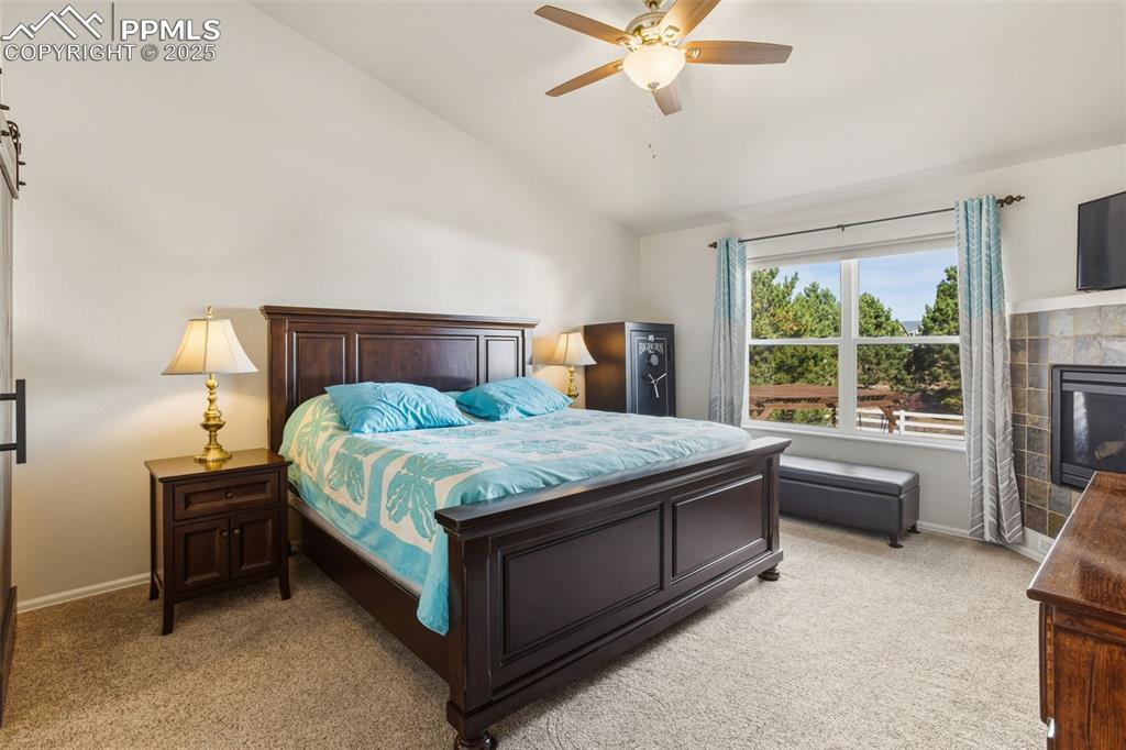 8449 Copenhagen Road Peyton, CO 80831 - Photo 23 of 49 a bedroom with a bed and a chandelier