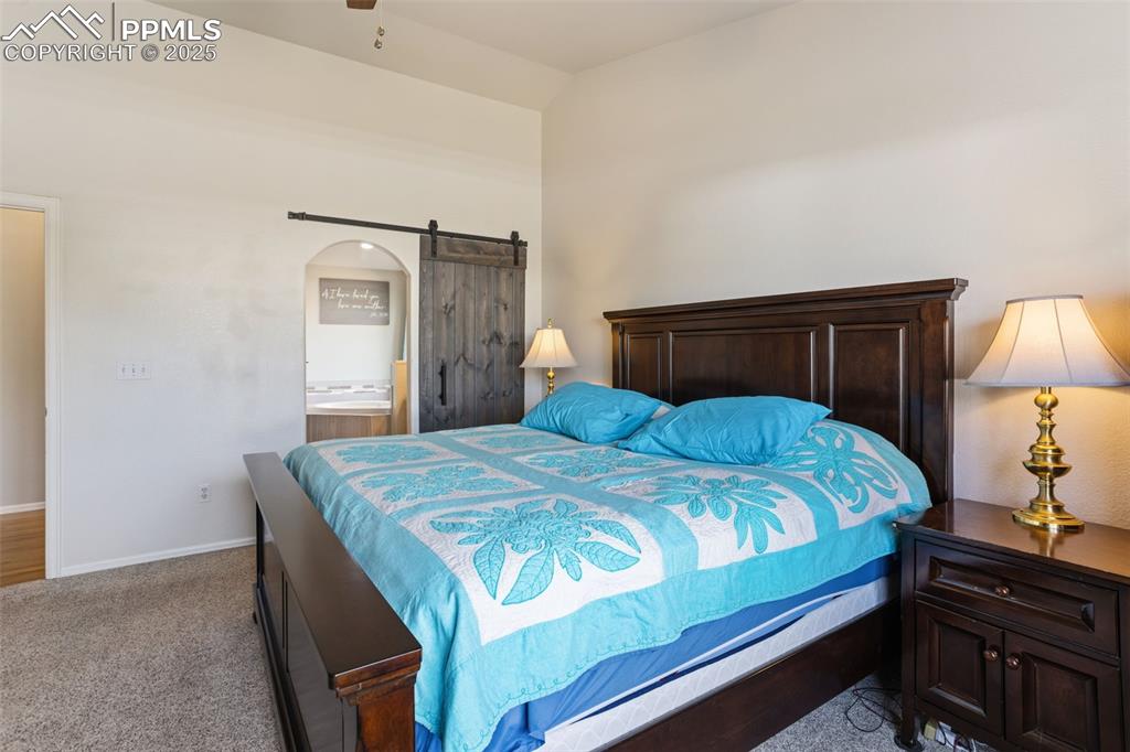 8449 Copenhagen Road Peyton, CO 80831 - Photo 24 of 49 a bedroom with a bed and a lamp on table