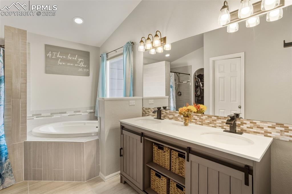 8449 Copenhagen Road Peyton, CO 80831 - Photo 25 of 49 a bathroom with a sink double vanity and a mirror