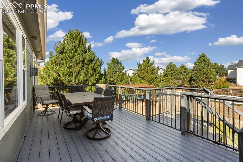 8449 Copenhagen Road Peyton, CO 80831 - Photo 41 of 49 a view of a balcony with chairs and wooden floor