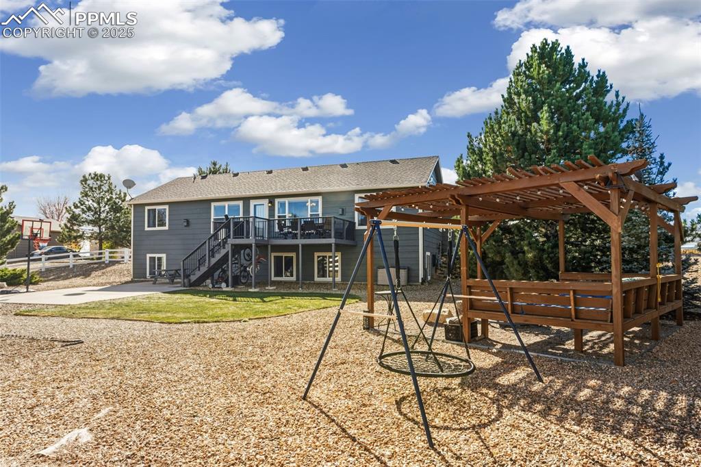 8449 Copenhagen Road Peyton, CO 80831 - Photo 43 of 49 a view of a swimming pool with a patio and a yard