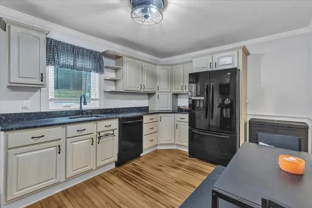 a kitchen with a refrigerator and a sink