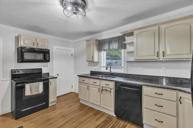 a kitchen with stainless steel appliances granite countertop a stove a sink and a microwave