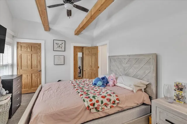 a bedroom with a bed and window