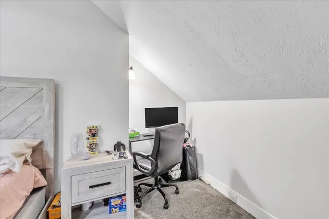 a view of a workspace with furniture and a potted plant