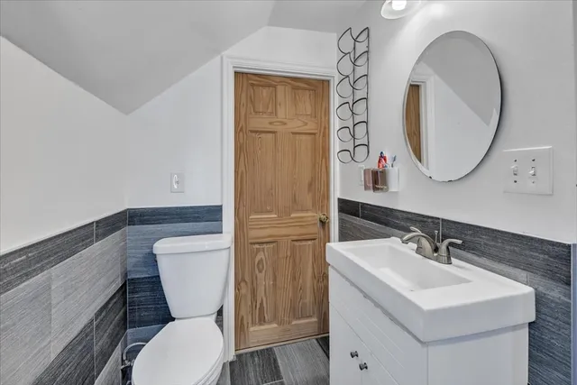 a bathroom with a toilet sink and mirror