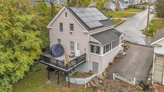 a aerial view of a house with a yard and furniture