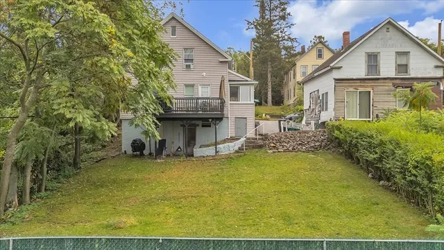 a view of house with garden and swimming pool