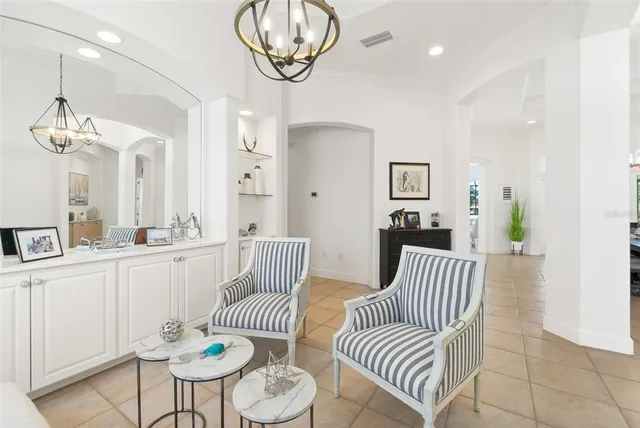 a kitchen with stainless steel appliances kitchen island granite countertop a table chairs microwave and sink