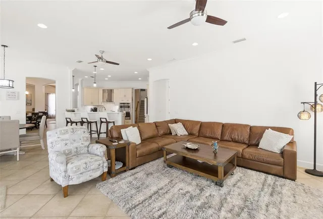 a living room with furniture large window and a fireplace