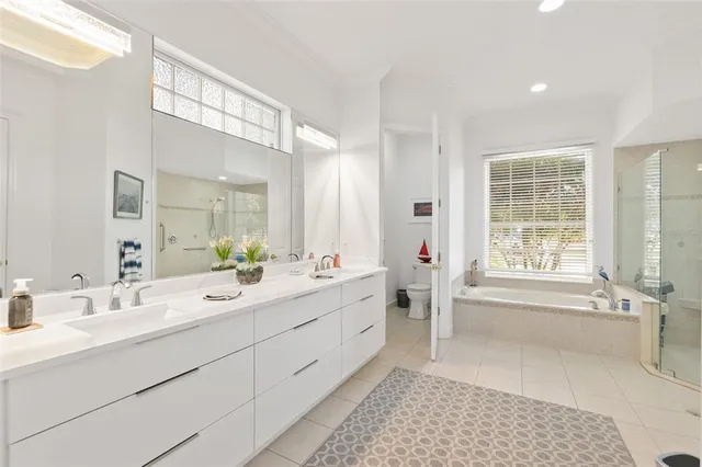 a bathroom with a granite countertop sink a mirror and shower