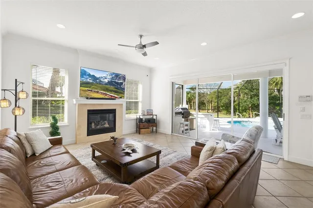 an aerial view of residential houses with outdoor space and trees