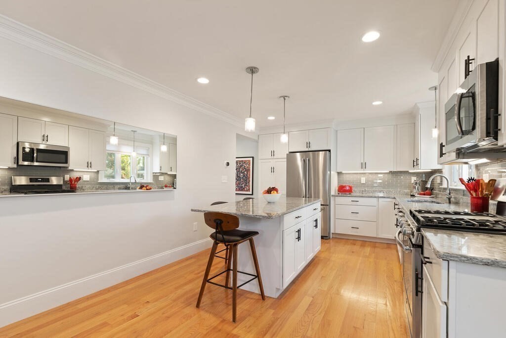 19 Foster Street, Unit 19 Arlington, MA 02474 - Photo 12 of 33 a kitchen that has a lot of cabinets a sink and appliances in it