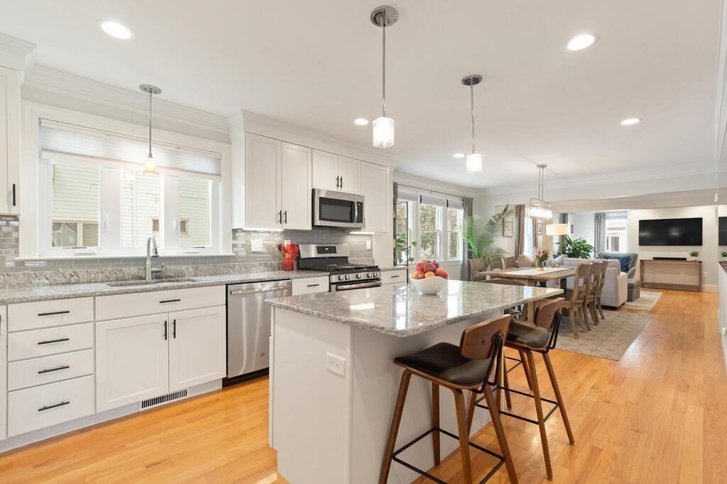 19 Foster Street, Unit 19 Arlington, MA 02474 - Photo 13 of 33 a large kitchen with kitchen island a large island in it